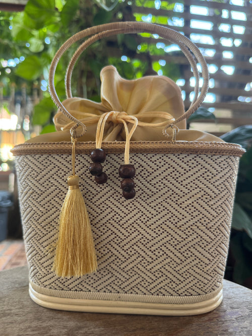 beige purse with tassel by thai kraft